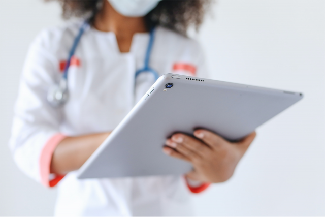 Photo of doctor holding ipad