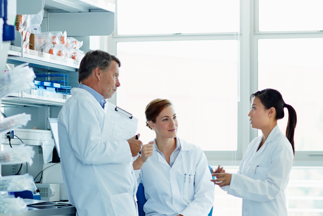 Three researchers discussing something.