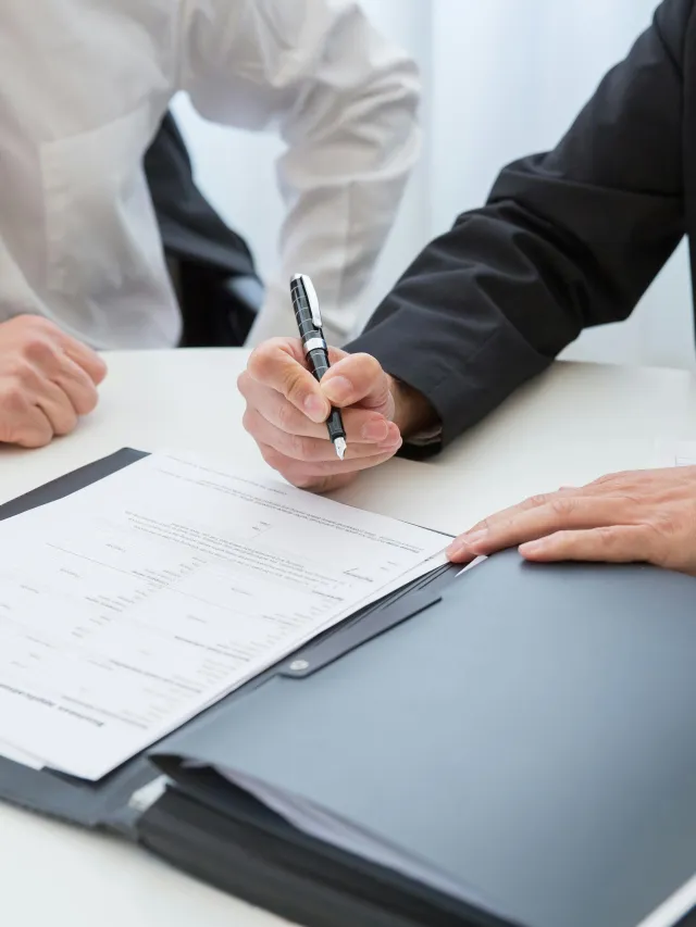 Hands signing document